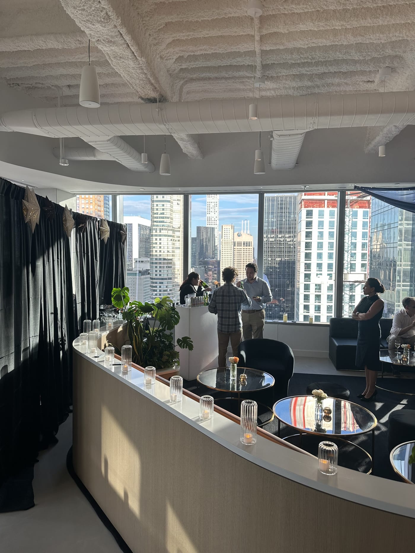 Manhattan office event space with skyline views set up for a company holiday party with DJ sound and lighting