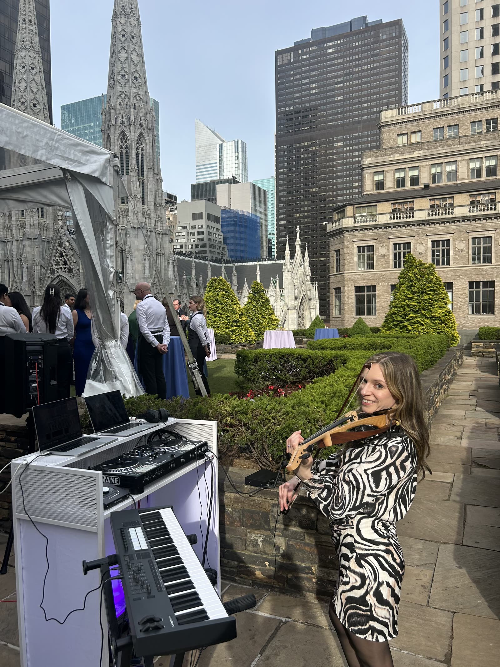 Live violin and DJ duo performance with Manhattan skyline and St. Patrick's Cathedral, 620 Loft & Garden rooftop, NYC