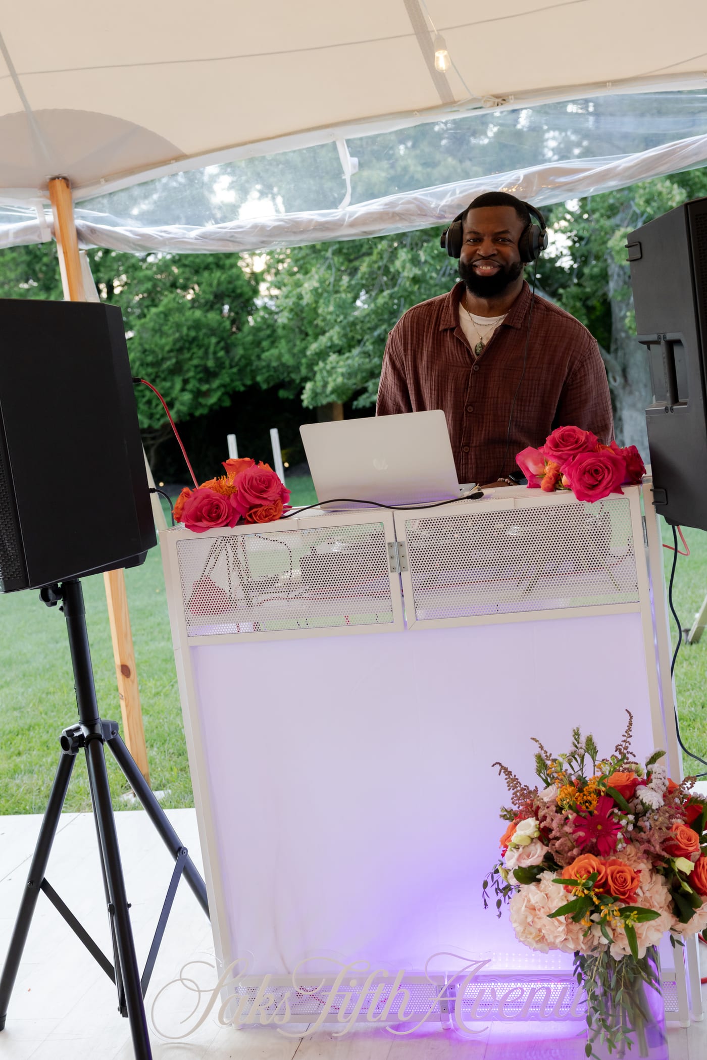 DJ DX behind the decks at a Saks Fifth Avenue private estate event in Water Mill, New York