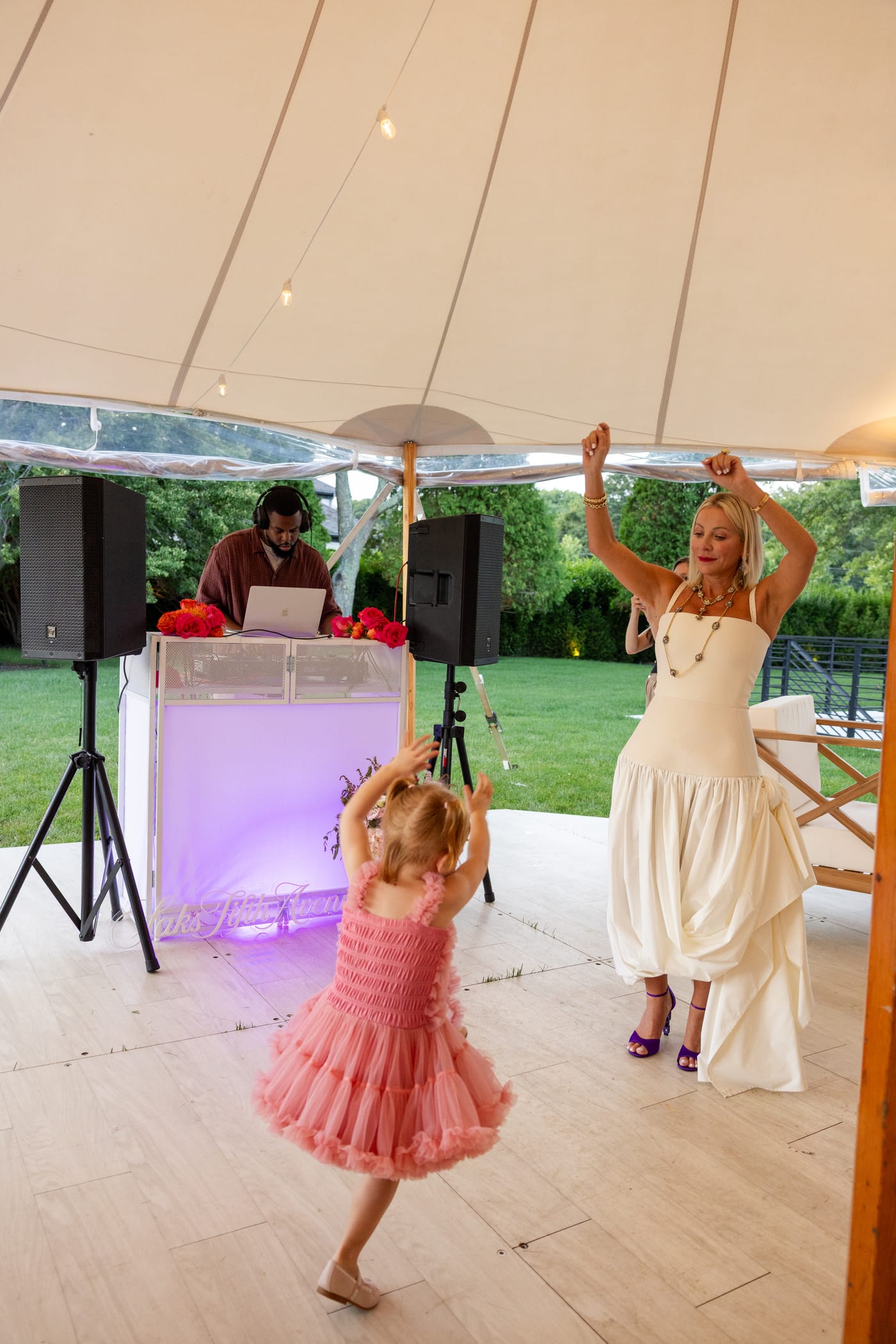 Guests dancing as DJ DX performs at a Saks Fifth Avenue private estate event in Water Mill, New York
