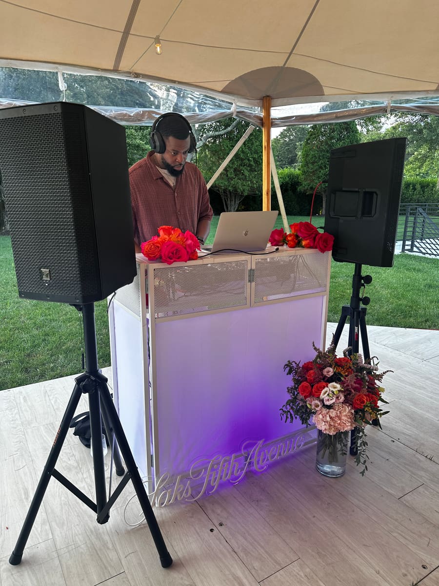 DJ DX mixing during a Saks Fifth Avenue private estate reception in Water Mill, New York