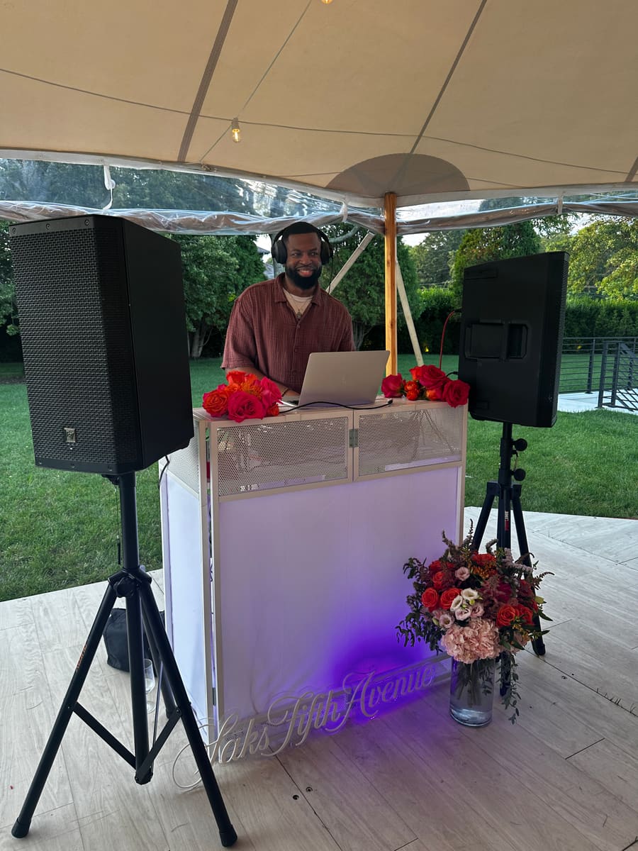 DJ DX performing at a Saks Fifth Avenue private estate event in Water Mill, New York