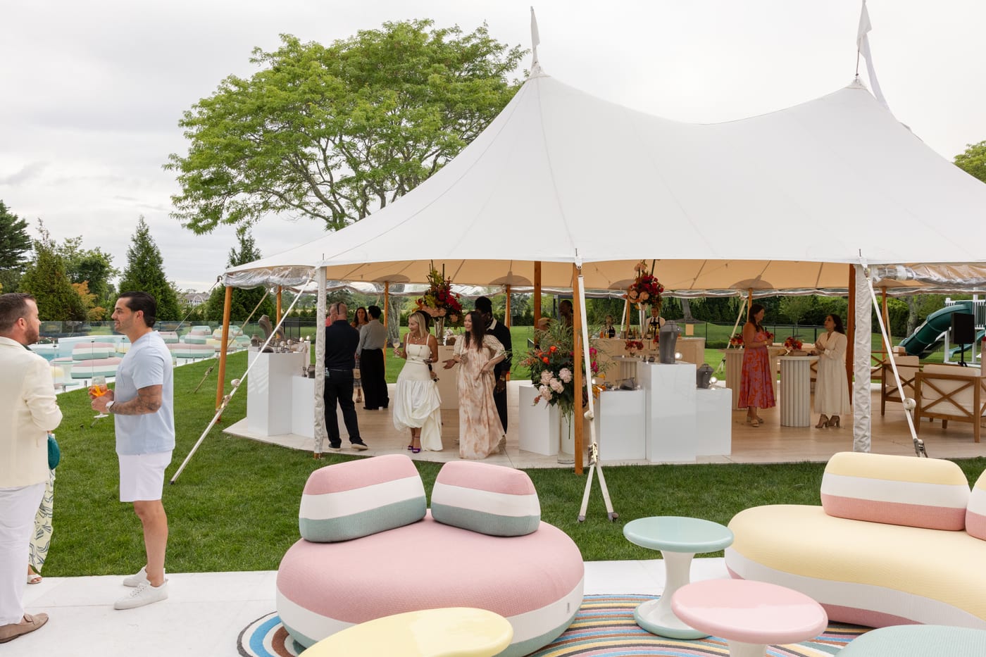 Poolside lounge and sailcloth tent at a Saks Fifth Avenue private estate event in Water Mill, New York